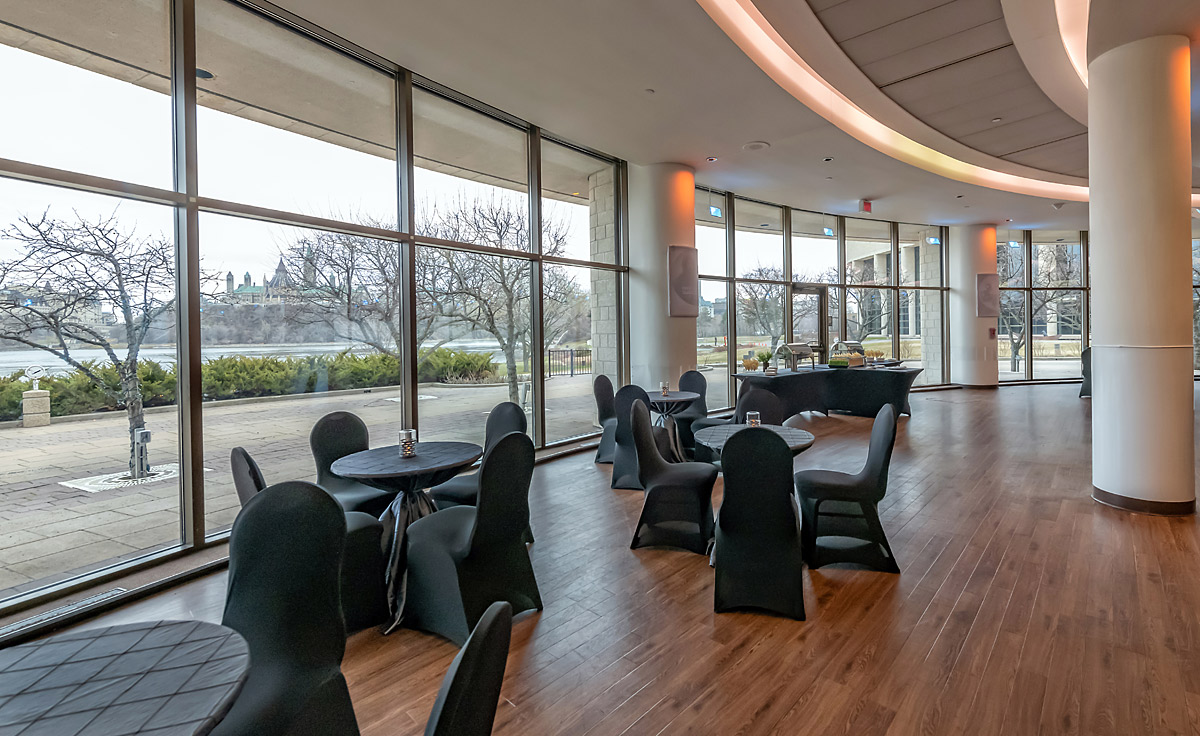 Une grande salle avec des tables et des chaises installées pour un mariage au Musée canadien de l'histoire à Ottawa.