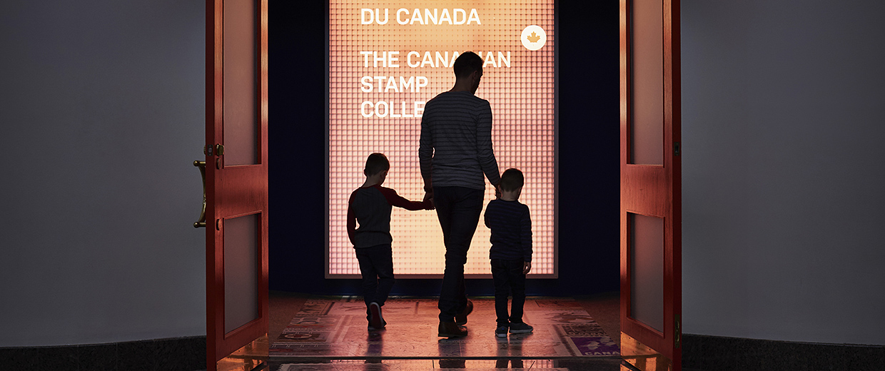 A man and a woman standing in front of a door at the Canadian Museum of History, in Ottawa.