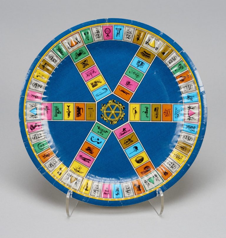 A Trivial Pursuit themed plate, depicting the board game's pinwheel design.