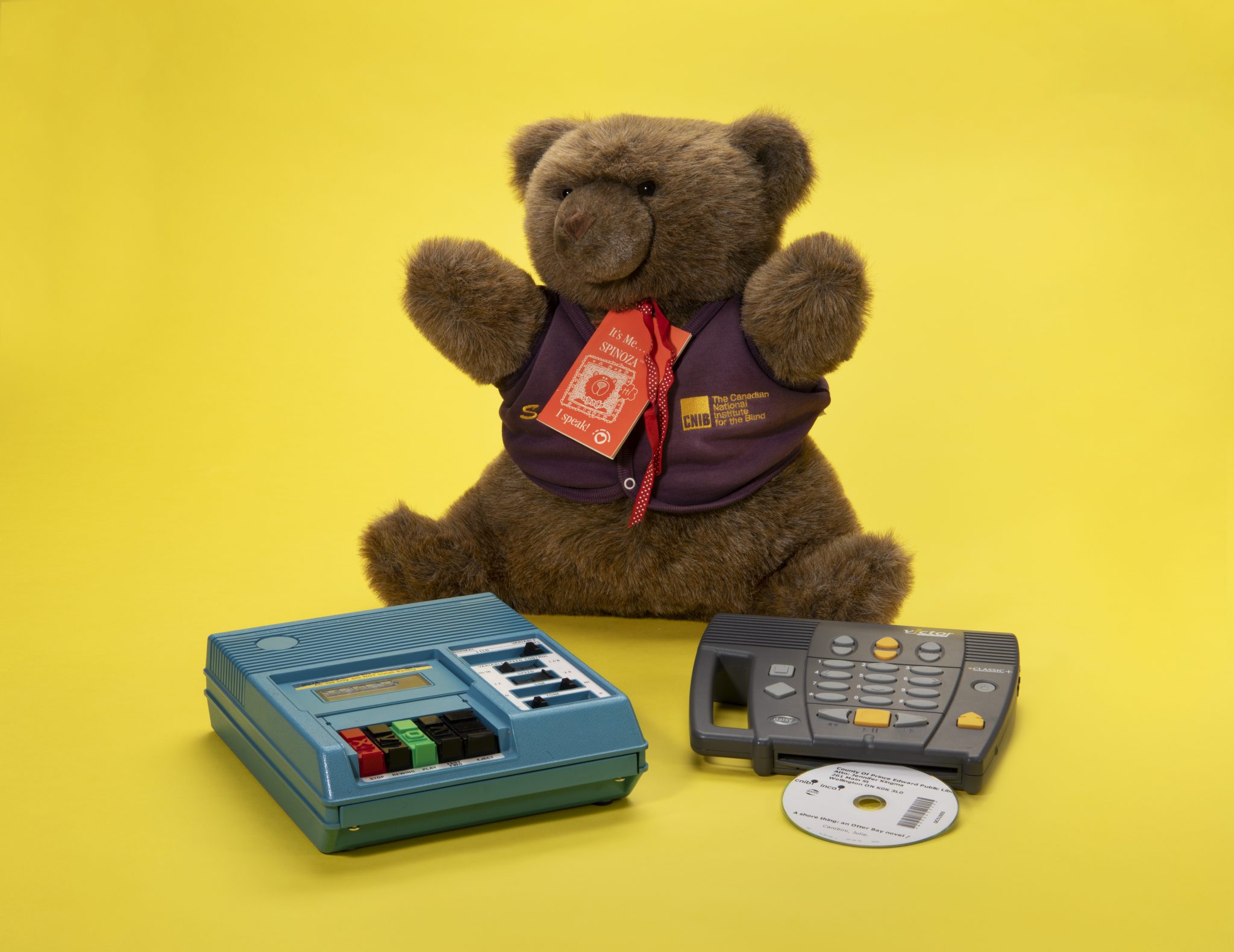 A teddy bear with two recording devices.